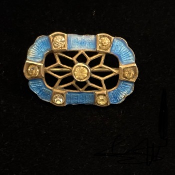 Silver white stone and blue enamel brooch.