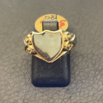 18ct yellow gold shield shaped signet ring with engraved shoulders.
